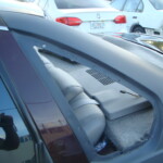 Before and after photographs of a damaged Chevy Impala that was repaired by Elite Paint & Body Shop in West Palm Beach, Florida.